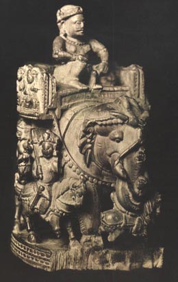 A traditional carving of a royal figure on an elephant back (on a howda), probably the original form of the shatranj chess king